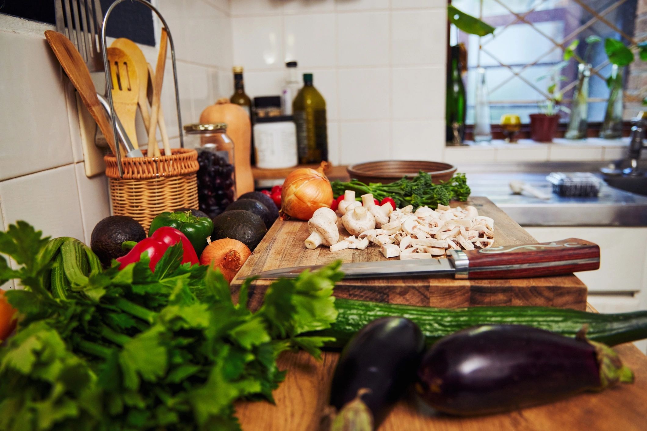 Shot of fresh vegetables on a chopping board in a kitchen at home